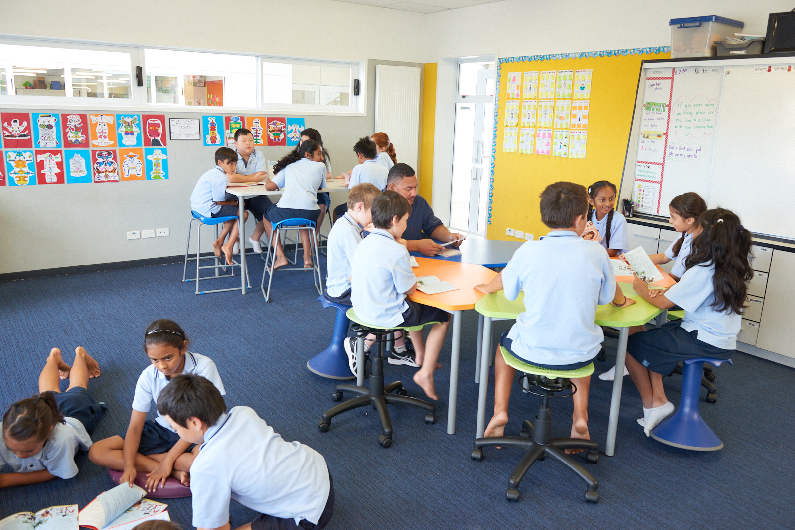 Students working in groups in an open plan classroom