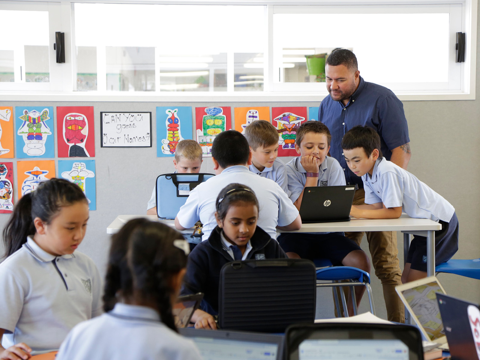 School children working in groups, with a teacher